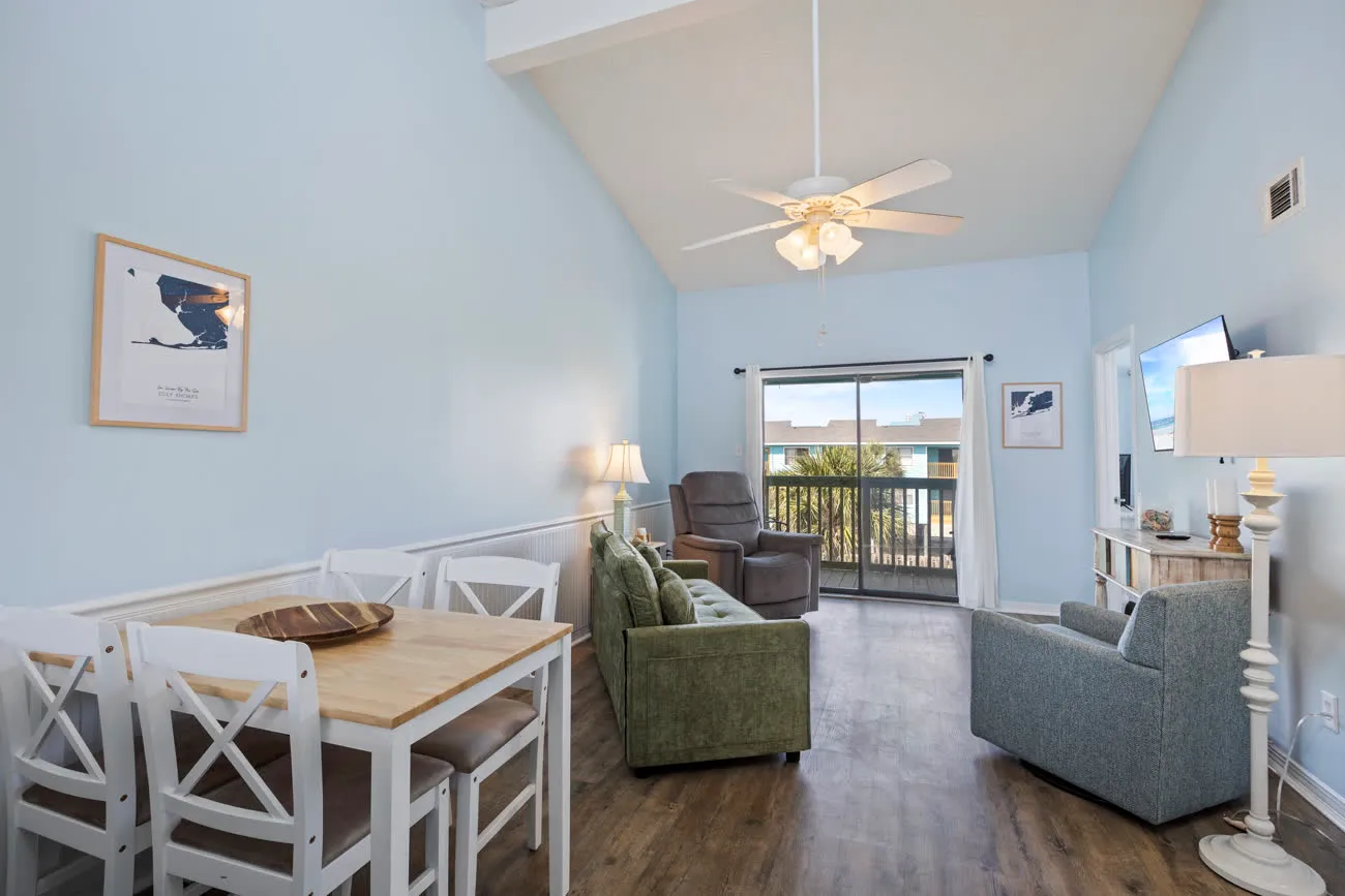 Wide living room with dining table, sofa, recliner, and ceiling fan
