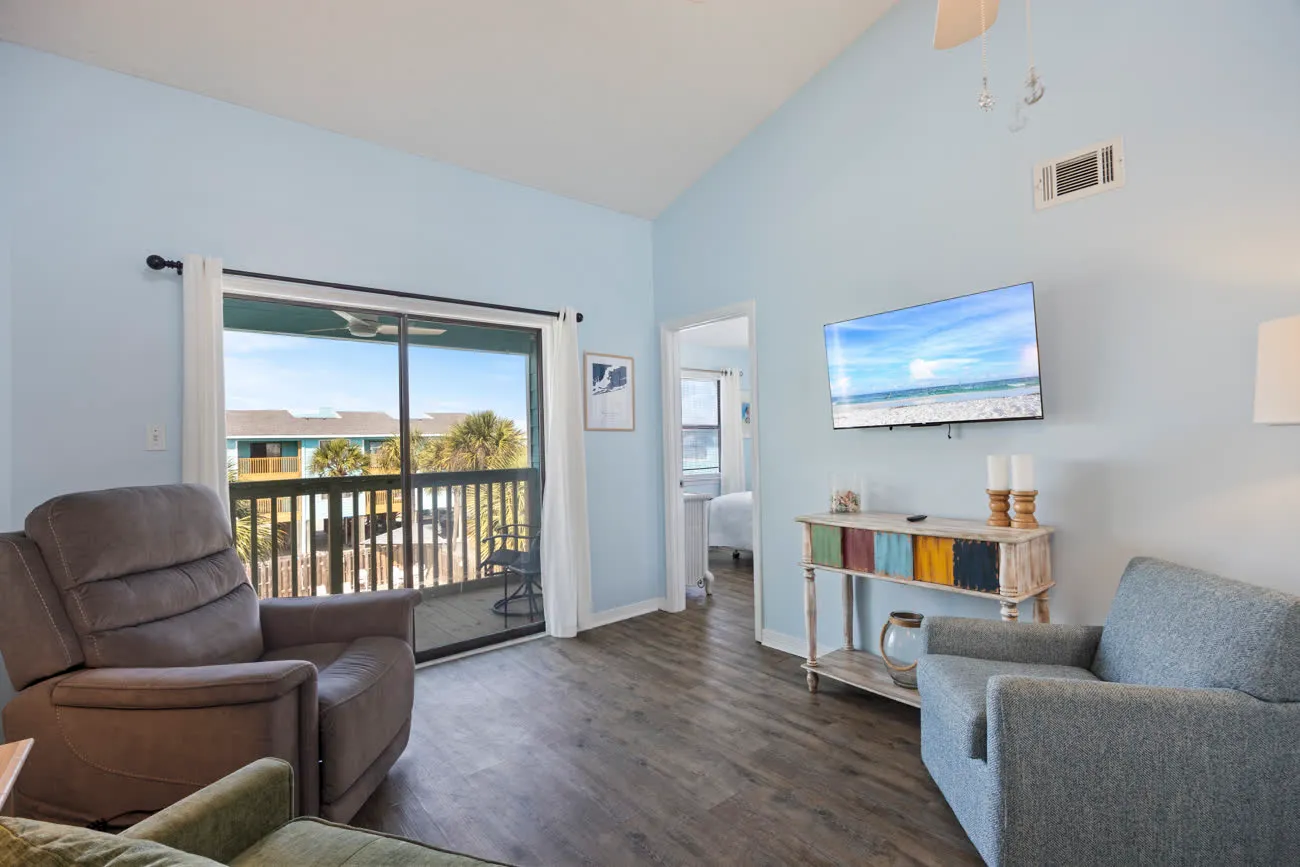 Living room with smart TV and sliding door to balcony