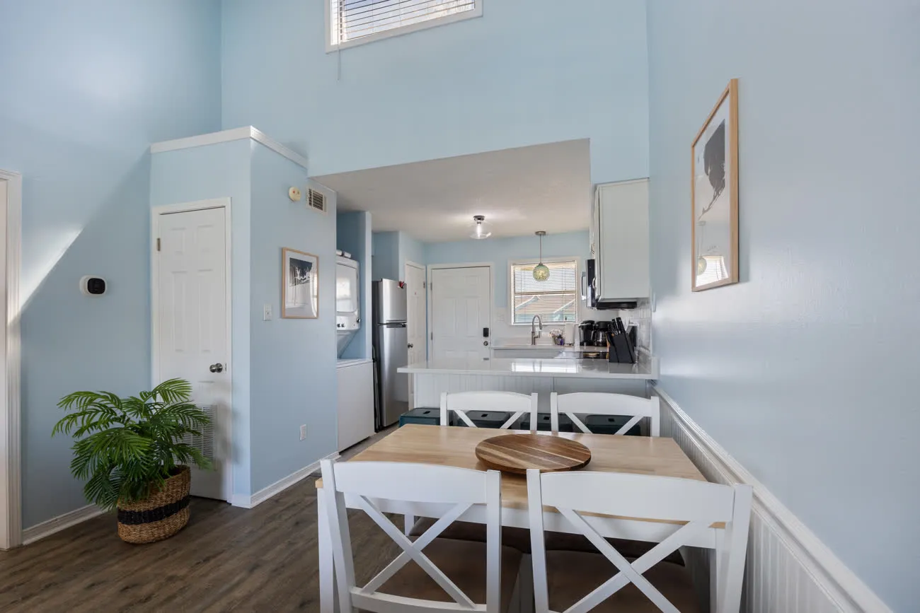 Dining table with view through to kitchen and entry door