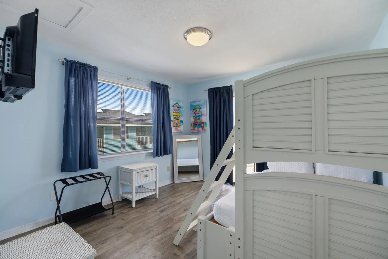 Second bedroom with bunk bed and window