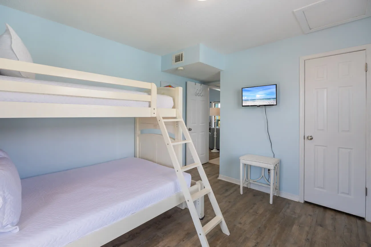 Second bedroom bunk bed with wall-mounted TV
