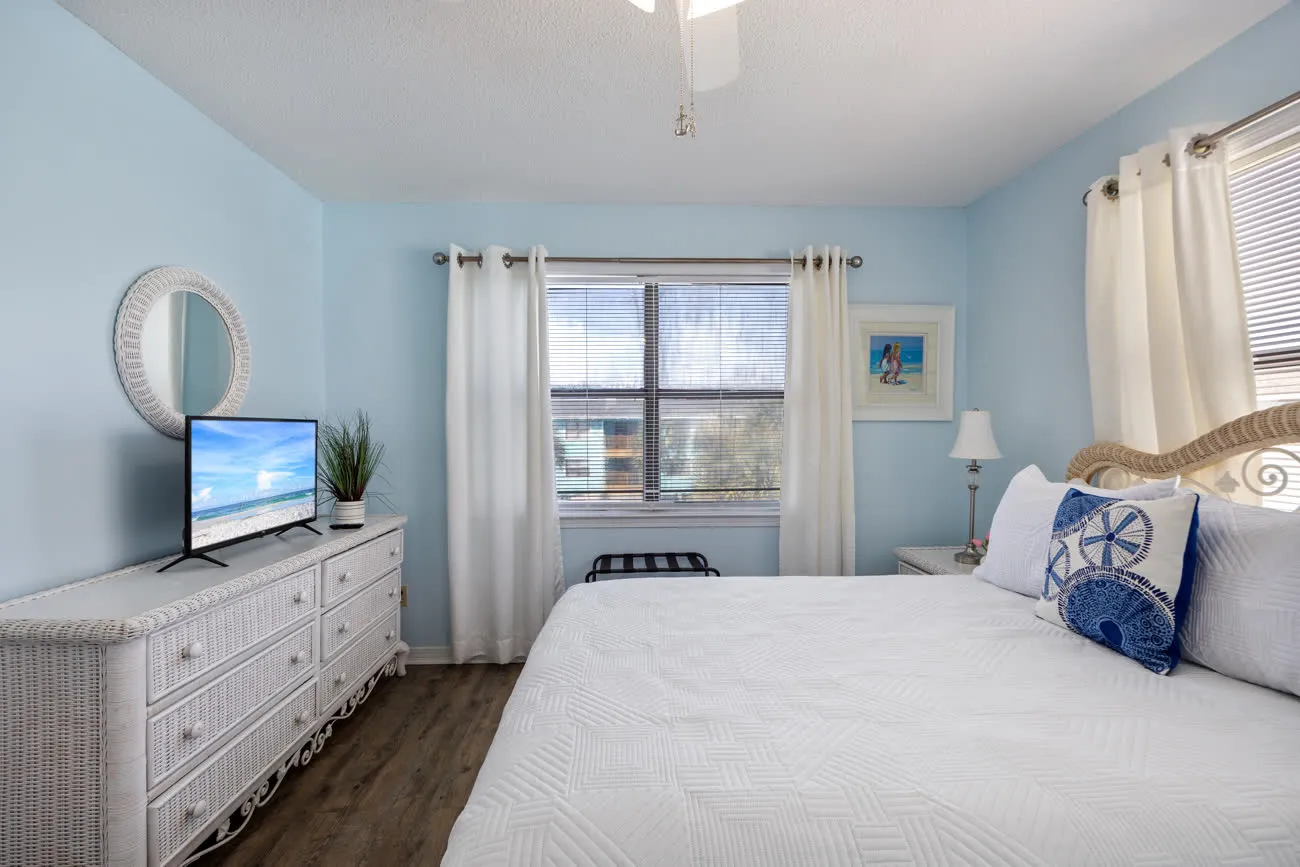 Master bedroom with TV, dresser, and queen bed