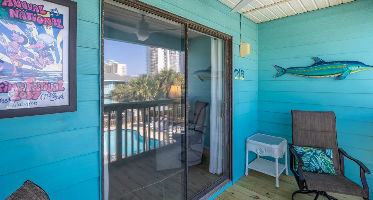Private balcony with sliding door, fish art, and pool view