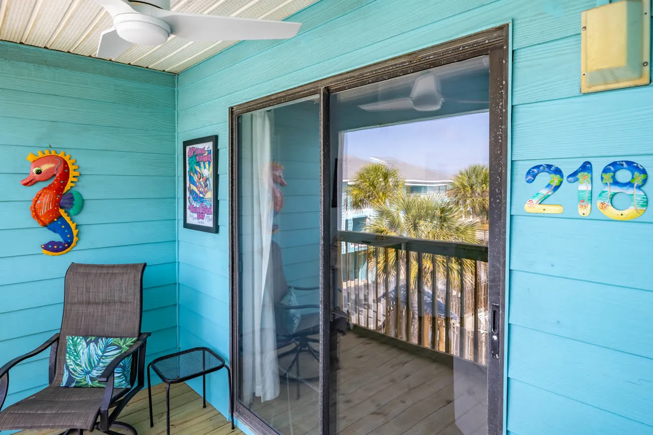 Unit 218 entry porch with seahorse art and chair