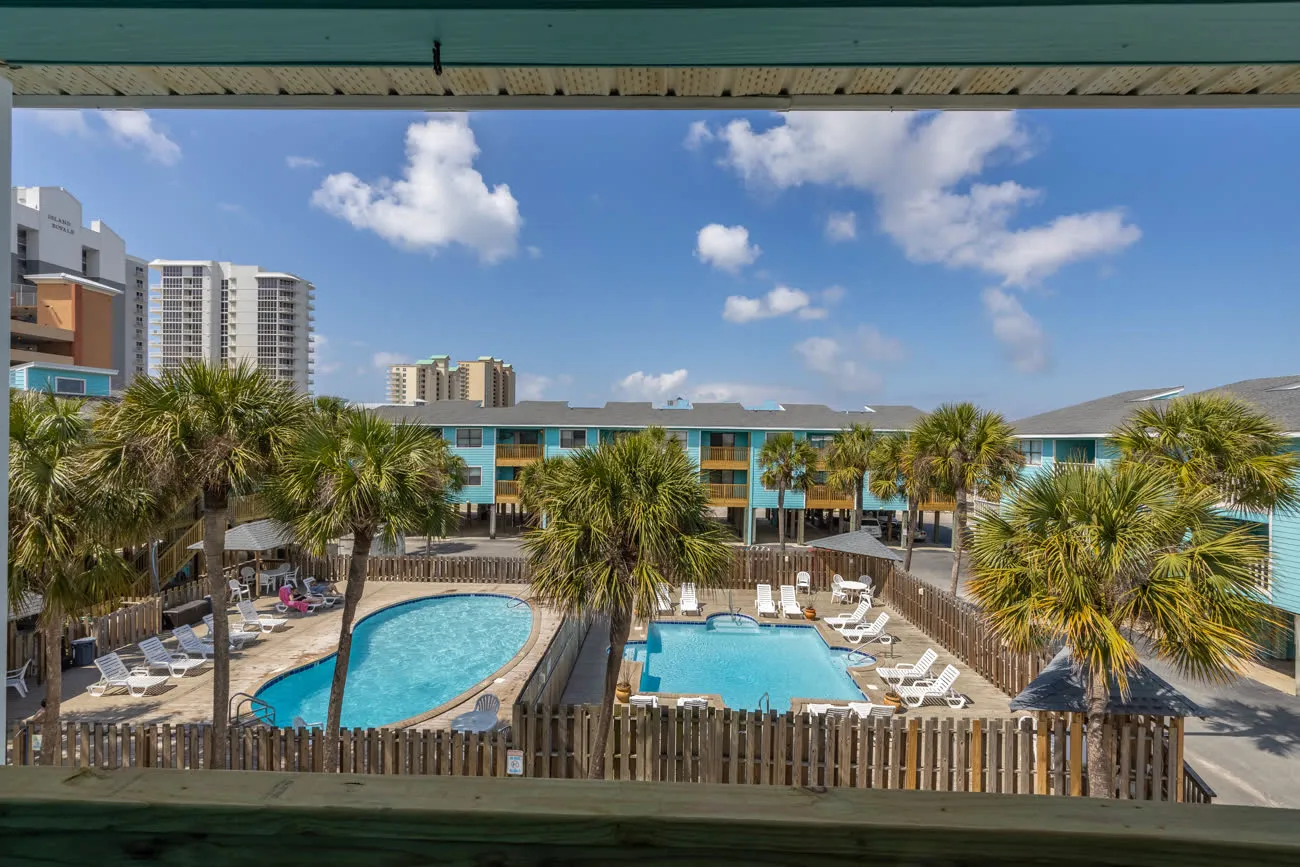 Both pools wide view through balcony railing